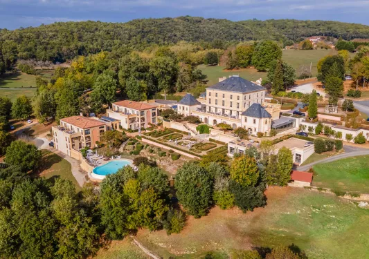 outdoor view of large hotel surrounded by trees