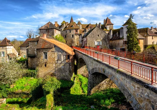 stone bridge with stone buildings in the back