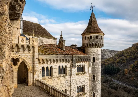 stone castle with mountains in the background