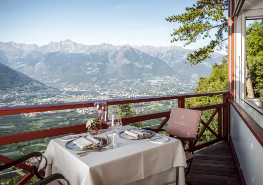 table on balcony with view of mountain range