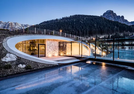 Modern hotel pool entrance with mountains in the background