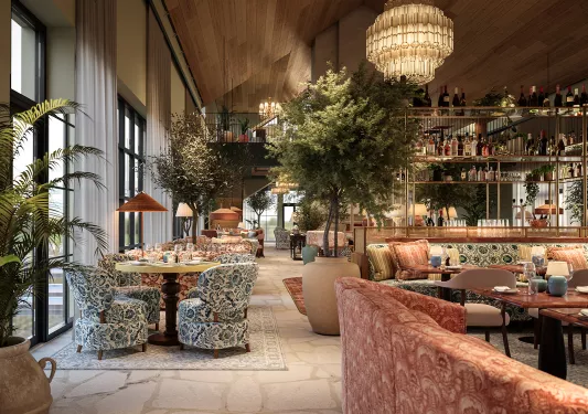 Indoor dining hall with blue and red cushioned seats and a wine rack in the center