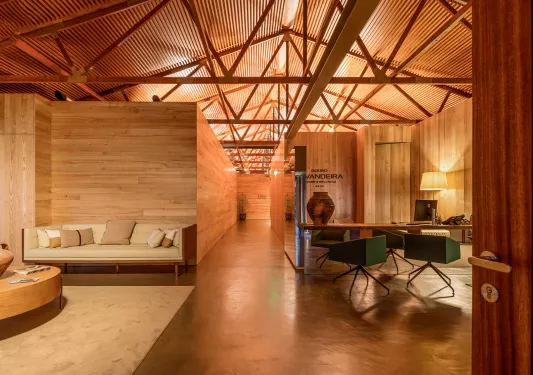 Indoor lobby surrounded by wood veneer walls