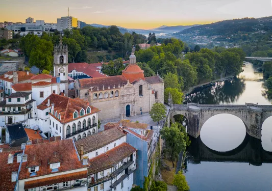 Ancient castle-like buildings with a bridge connecting to the town