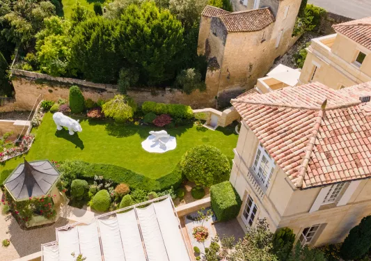 Birds eye view of hotel surrounded by grass