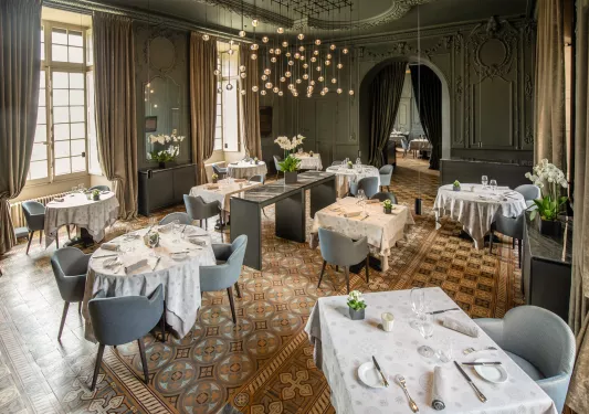 ballroom with dining tables and a chandelier