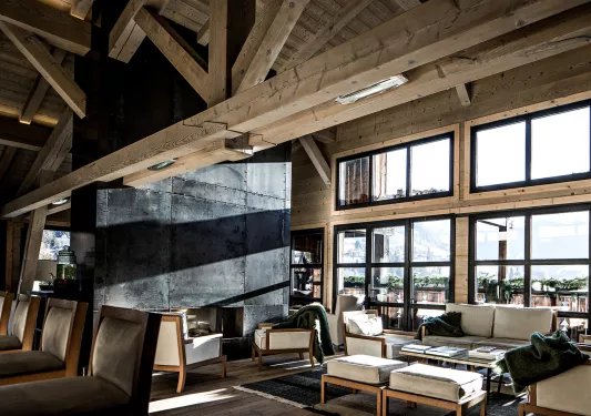 Lounge with wooden interior looking out to the forest