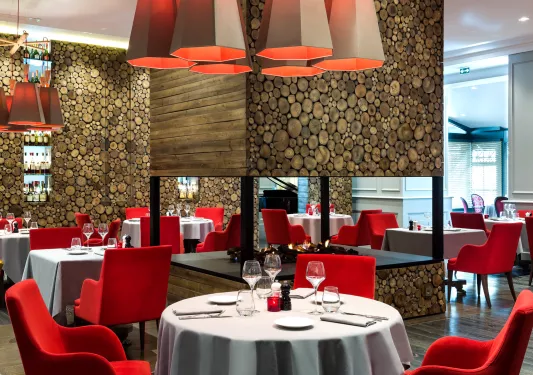 dining room with red chairs and fireplace in the middle