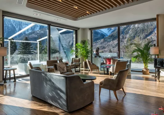 Indoor lounge with large windows looking out to mountains