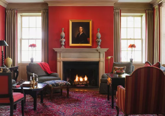 red living room with fireplace and portrait