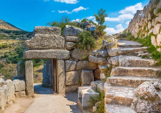 Rustic walkway with stone stairs and archways