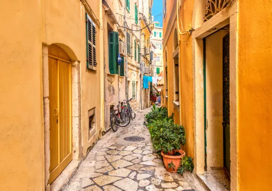 A narrow cobblestone pathways surrounded by orange houses