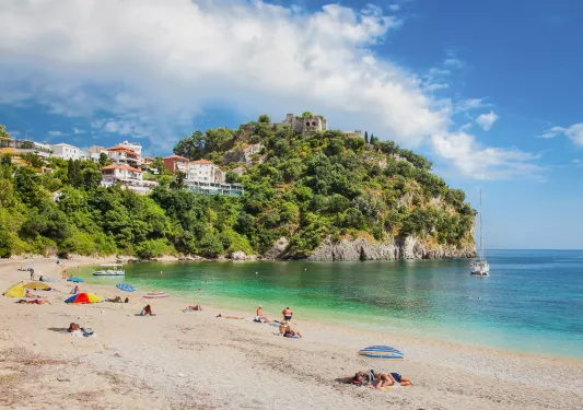Sunny beach with a cliff in the distance