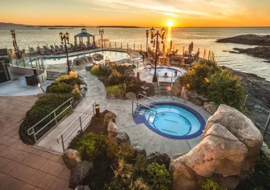 Bids eye view of hot tub and pool area at sunset