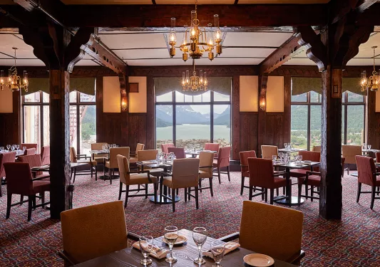 Indoor dining area with wine glasses and yellow and red seats