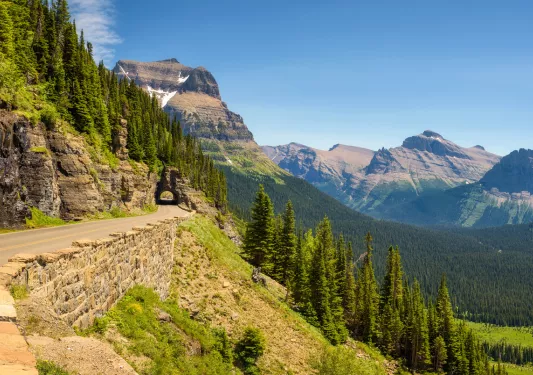Long road along a cliff with trees in the distance