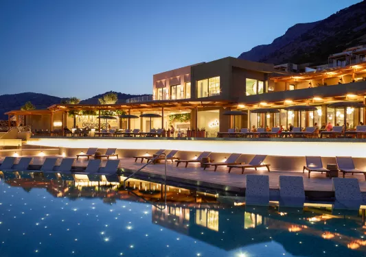 Hotel with bright orange lights with a pool in the center