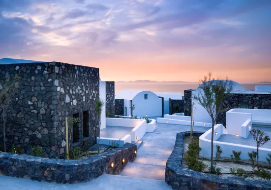 Gray and white stone villas with pathways leading to each doorway