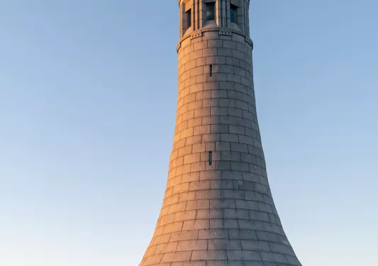 Sunset hitting a stone lighthouse