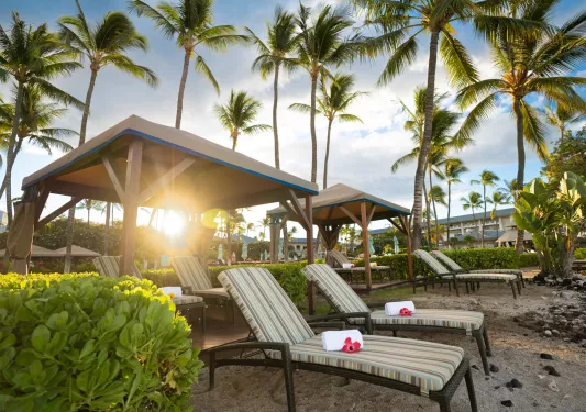 Rolled towels on reclining chairs by the beach