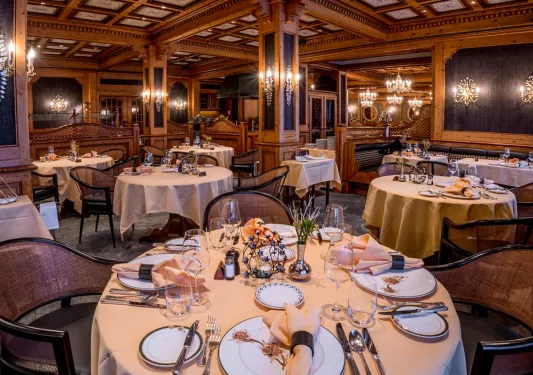 Indoor dining area with wine glasses and tables cloths