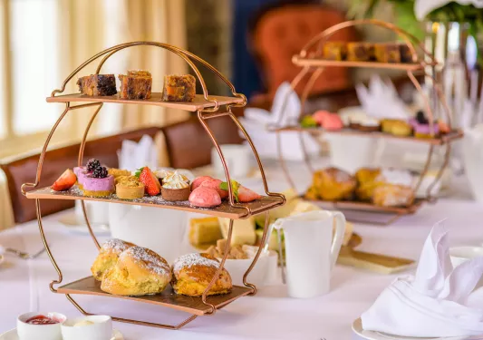 Two racks of pastries on top of a white table