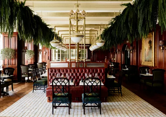 Indoor dining area with red cushioned booths and green chairs