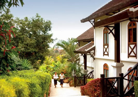 two women walking up the stairs towards hotel