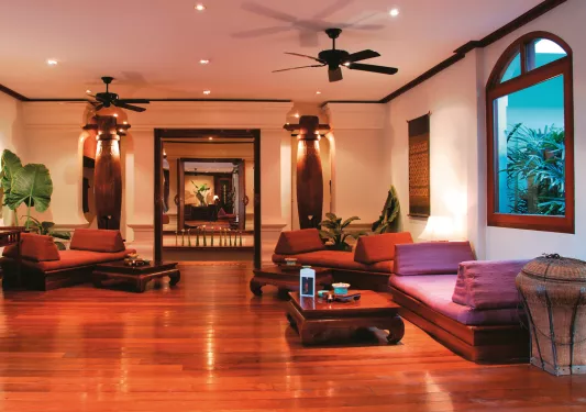 room with red lighting and low couches