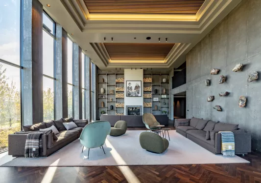Indoor lounge with gray sofas and art fixtures along the walls