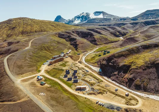 Hotel property in the middle of an empty valley of dirt and grass