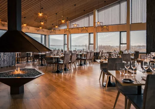 large dining room with fireplace and large windows