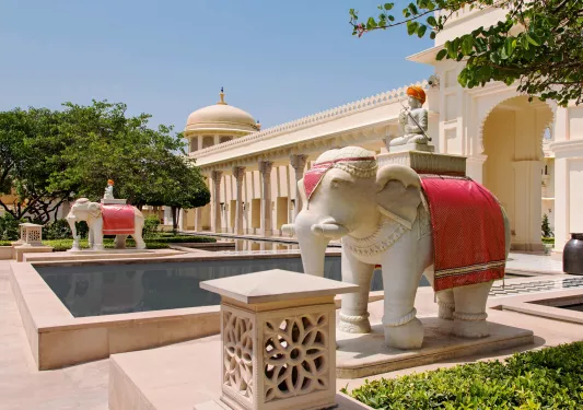 Outdoor courtyard with a rectangle pool and two statues of elephants