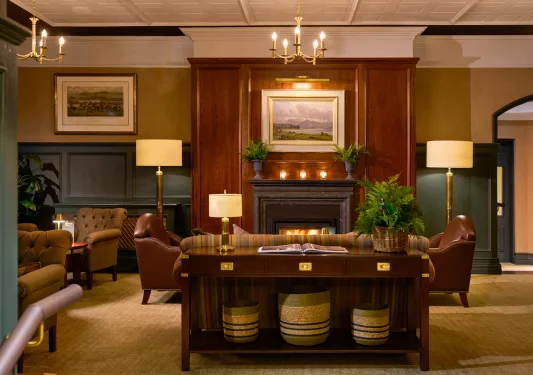 Hotel lobby with wooden fireplace and cushioned seats