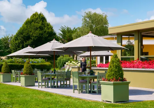 Outdoor seating area with chairs , tables and umbrellas
