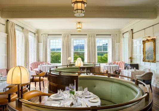 Half-circle shaped seating booths with a dining table in the center