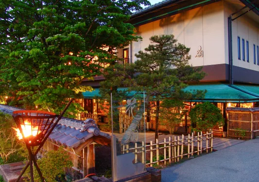 Building with traditional Japanese barricades, surrounded by trees