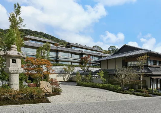 Japanese-style hotel building with stone statues in the courtyard