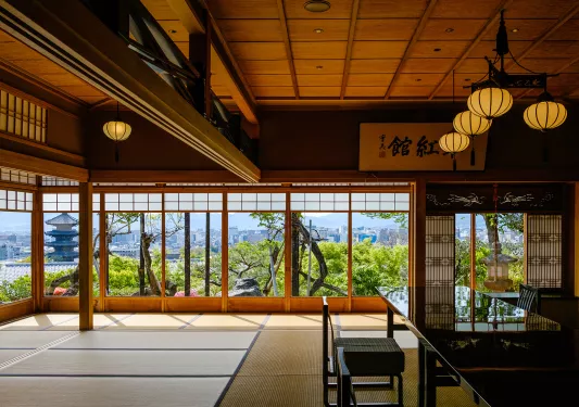 Japanese interior with black shiny tables and tatami mats on the floor