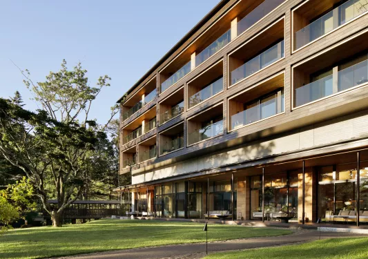 Exterior of a multi-story building with glass balconies on each level
