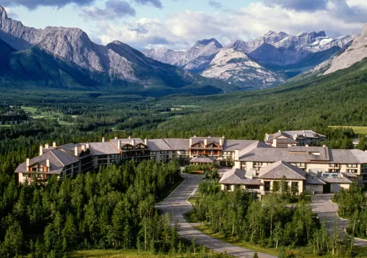 Long hotel building surrounded by a forest of trees