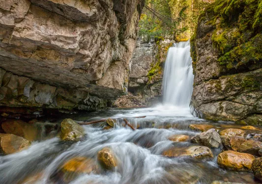 Small river with a waterfall in the background