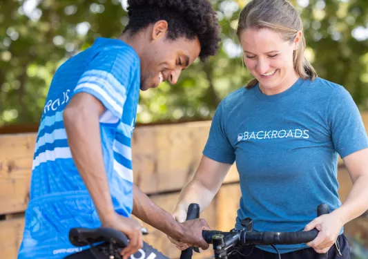 Man and woman holding on to a performance bicycle