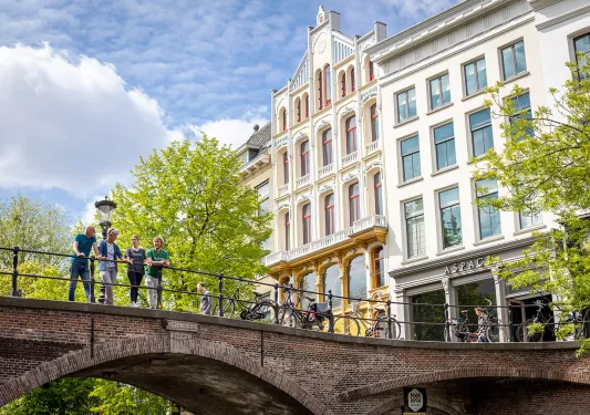 Group of people on a bridge in a town center