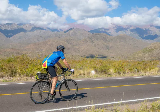 person biking down a road