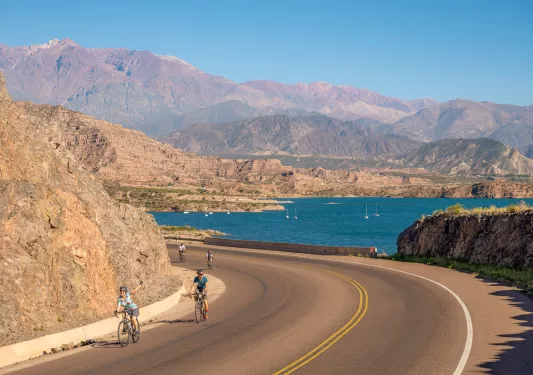 Cyclists riding by the water