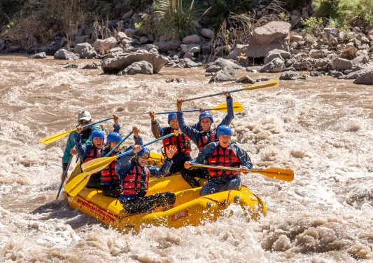 group of people white water rafting