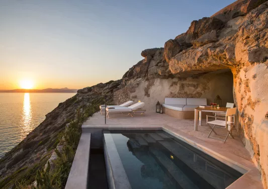 pool deck overlooking sunset on the water