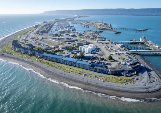 Peninsula of long hotel buildings next to the ocean