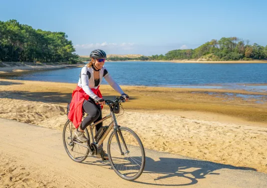 Backroads guest cycling by the water